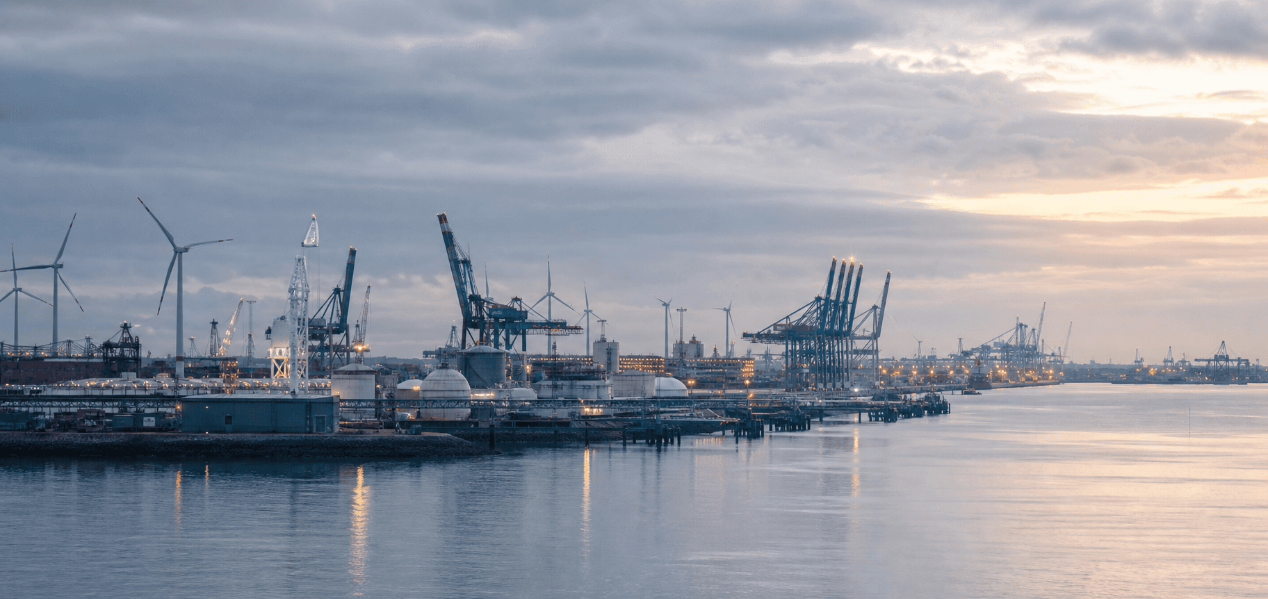 A broad port landscape spanning industrial, liquid bulk and container terminal environments